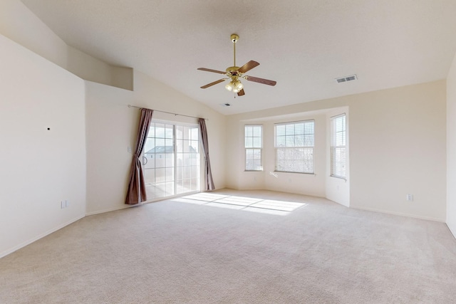 carpeted empty room with ceiling fan and lofted ceiling