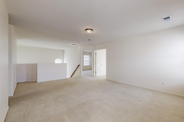 empty room featuring light colored carpet