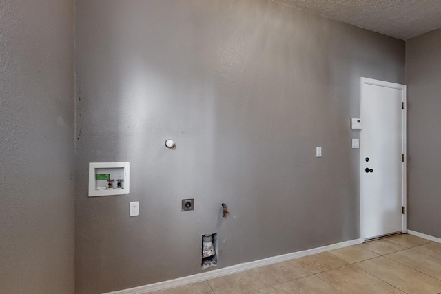 washroom featuring washer hookup, hookup for an electric dryer, hookup for a gas dryer, a textured ceiling, and light tile patterned floors