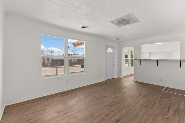 entryway with a textured ceiling and dark wood-type flooring