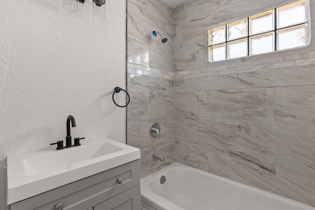 bathroom with vanity and tiled shower / bath