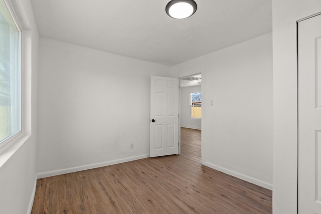 spare room with hardwood / wood-style floors