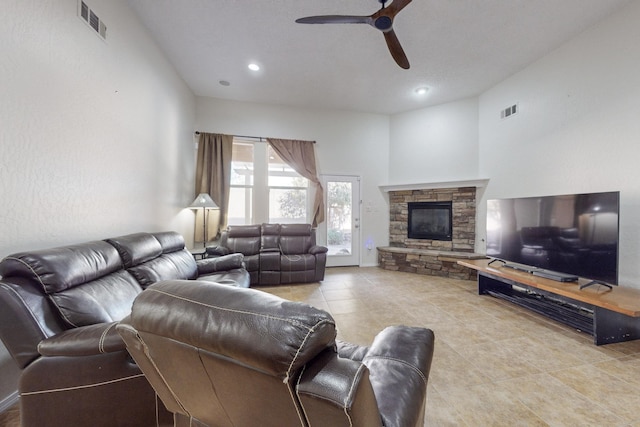 living room featuring a fireplace and ceiling fan