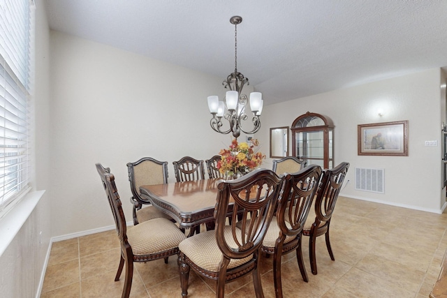 tiled dining area with a notable chandelier