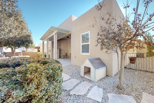 back of house with a pergola and a patio area