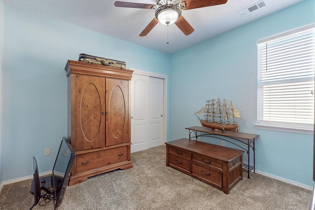 interior space with light carpet and ceiling fan