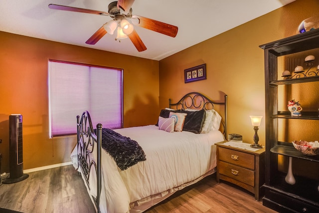 bedroom with hardwood / wood-style floors and ceiling fan