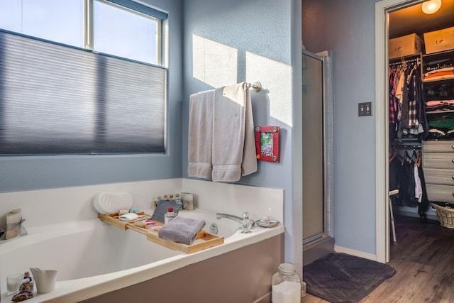 bathroom with wood-type flooring and separate shower and tub