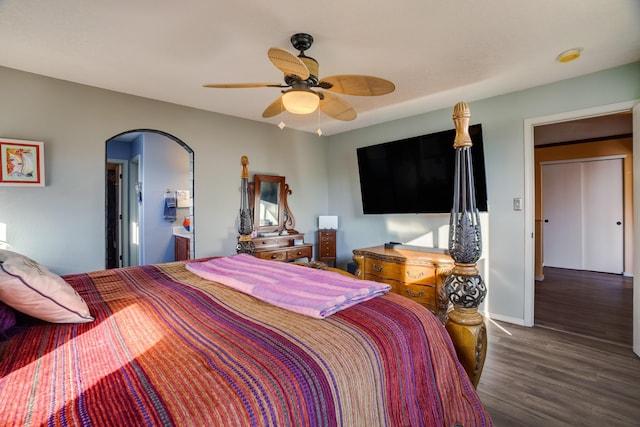 bedroom featuring ceiling fan, dark wood-type flooring, and connected bathroom