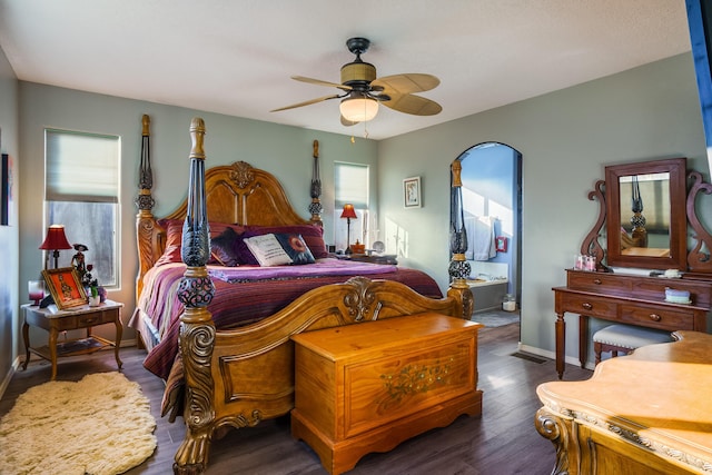 bedroom featuring connected bathroom, ceiling fan, and dark hardwood / wood-style floors