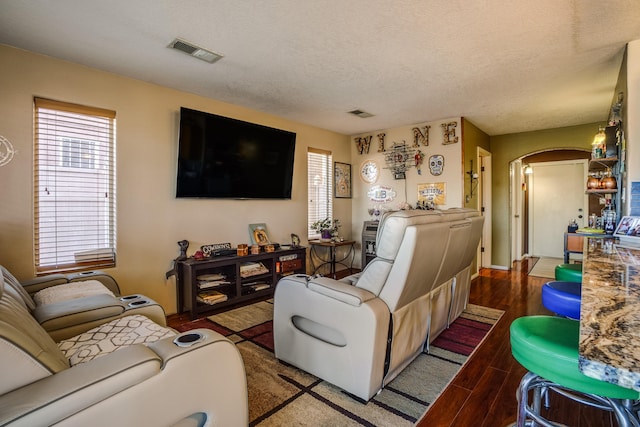 living room with hardwood / wood-style flooring and a textured ceiling