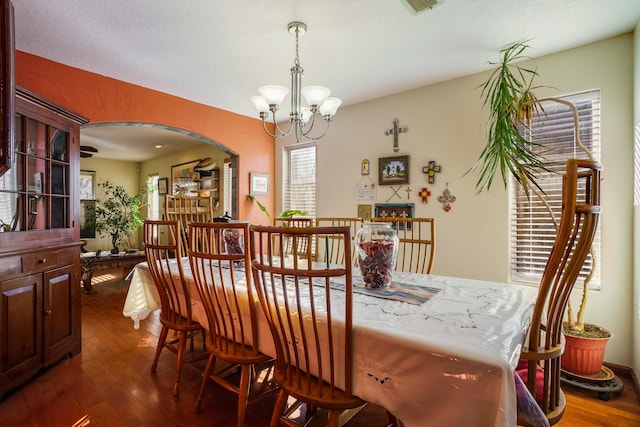 dining room featuring dark hardwood / wood-style flooring and a notable chandelier