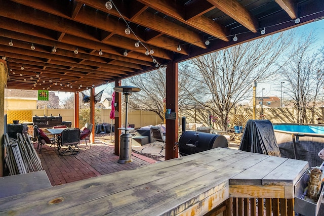 wooden deck with grilling area, a bar, and a patio