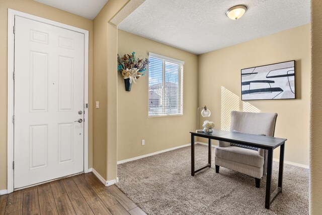 office area with a textured ceiling and hardwood / wood-style flooring