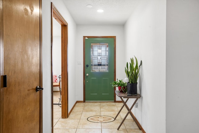 entryway featuring a textured ceiling and light tile patterned flooring