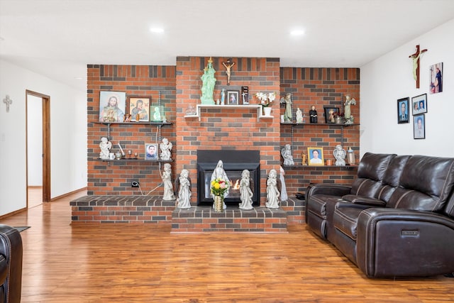 living room featuring hardwood / wood-style flooring and a fireplace