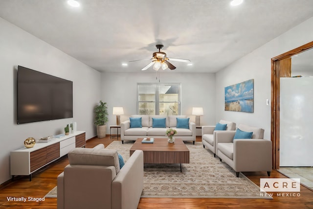 living room featuring ceiling fan and hardwood / wood-style flooring