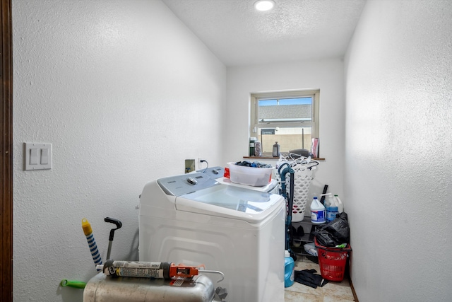 laundry area with a textured ceiling and separate washer and dryer