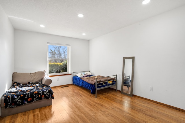 bedroom with hardwood / wood-style flooring