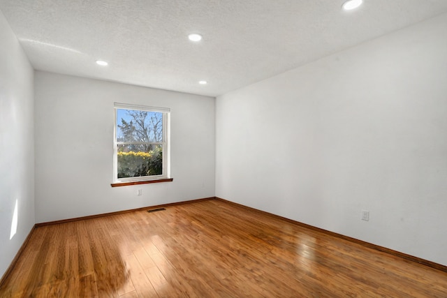 empty room featuring wood-type flooring