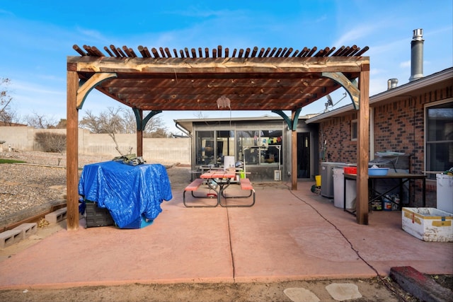 view of patio featuring a pergola, area for grilling, and a sunroom