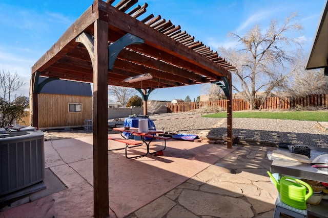 view of patio / terrace with a pergola, central AC, and a storage shed