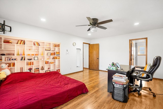 bedroom with ceiling fan and hardwood / wood-style flooring