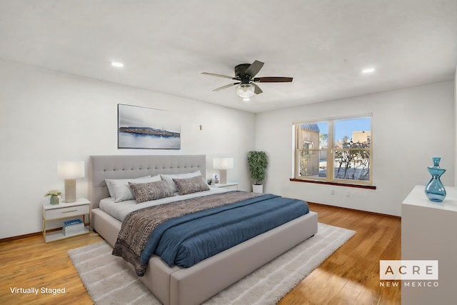 bedroom featuring light wood-type flooring and ceiling fan