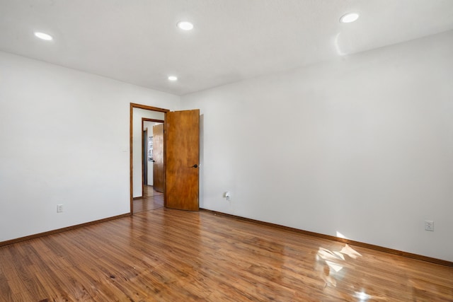 spare room with hardwood / wood-style flooring