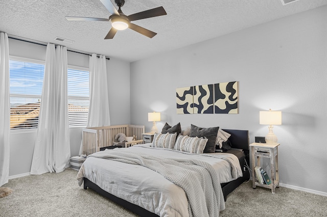 bedroom with baseboards, a textured ceiling, ceiling fan, and carpet flooring