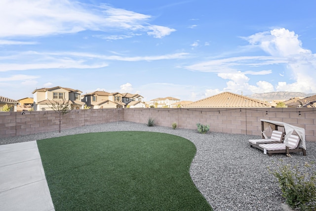 view of yard featuring a residential view and a fenced backyard