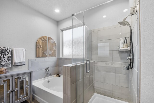 kitchen with backsplash, sink, a textured ceiling, appliances with stainless steel finishes, and white cabinetry