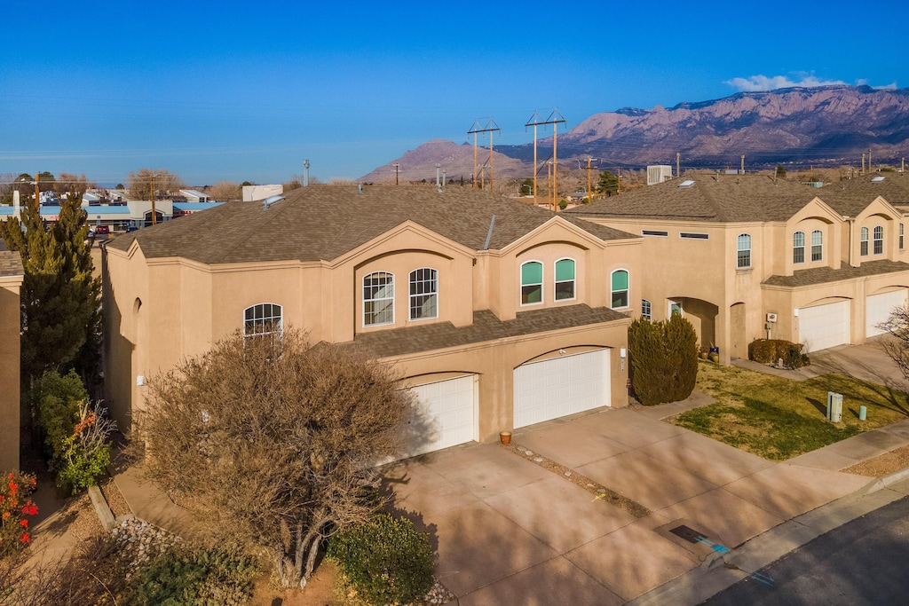 view of front of home with a mountain view and a garage