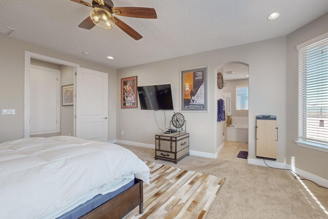 bedroom featuring heating unit, ceiling fan, light carpet, and a textured ceiling