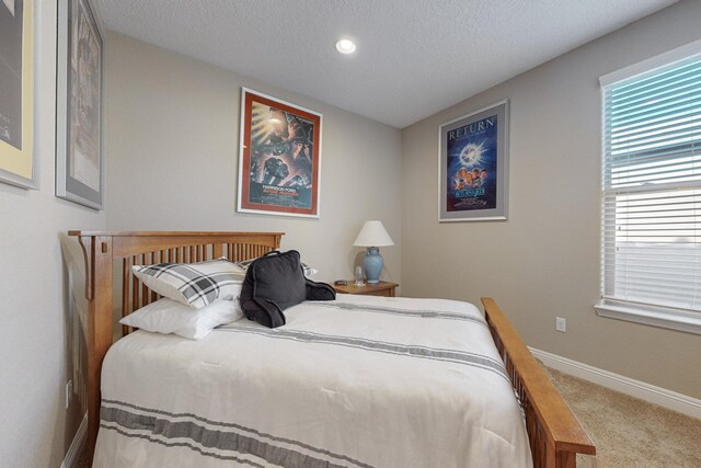 bedroom featuring a textured ceiling and carpet flooring