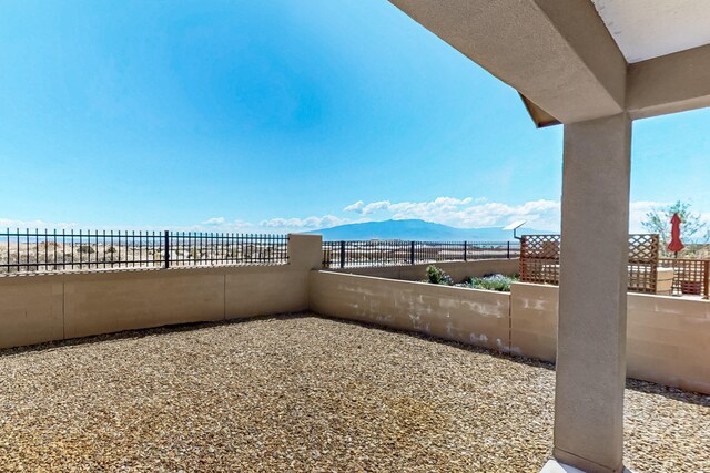 2923 Kings Canyon Loop NE, Rio Rancho, NM 87144 - view of patio / terrace with a fenced backyard and a mountain view