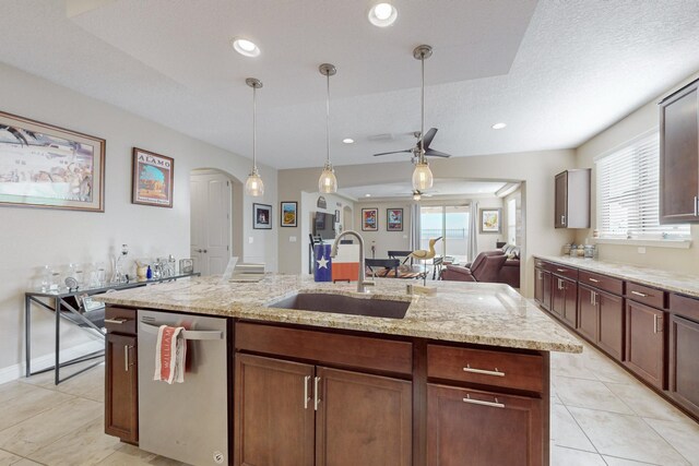 kitchen featuring sink, hanging light fixtures, a center island with sink, plenty of natural light, and dishwasher