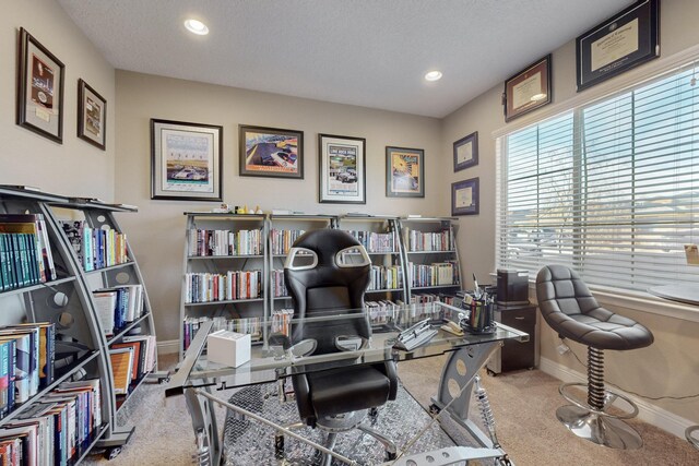 office area with carpet flooring and a textured ceiling