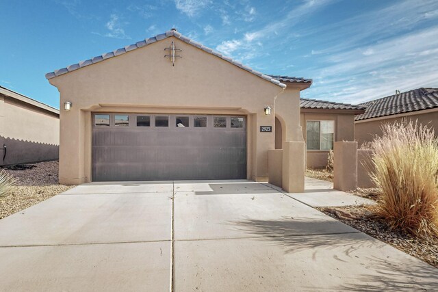 mediterranean / spanish-style home with a garage