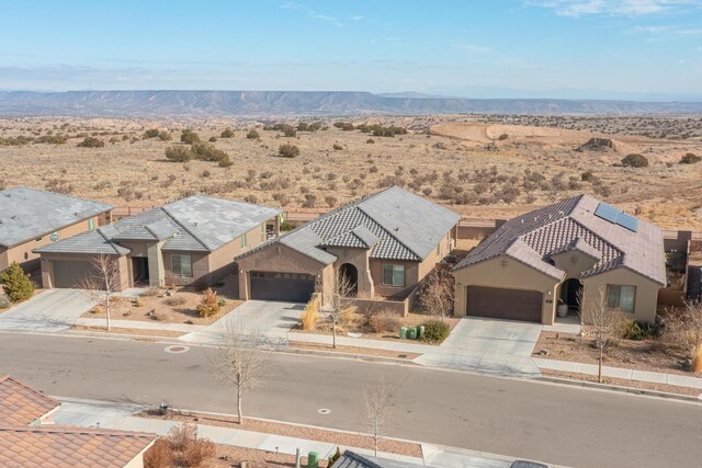 view of front of property featuring a garage and a mountain view