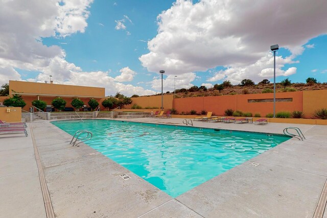 view of swimming pool with a patio area