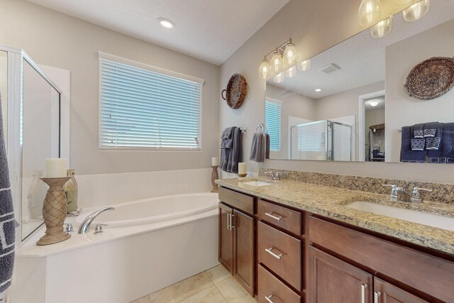 bathroom with vanity, tile patterned flooring, and shower with separate bathtub