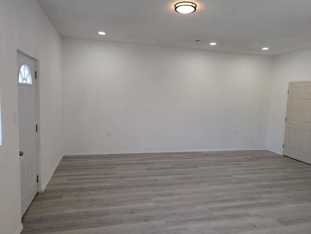 interior space featuring recessed lighting, baseboards, and wood finished floors