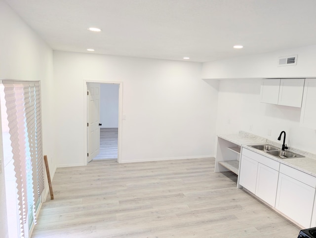 140 65th St NW, Albuquerque, NM 87105 - kitchen with a sink, open shelves, white cabinets, light wood-type flooring, and recessed lighting