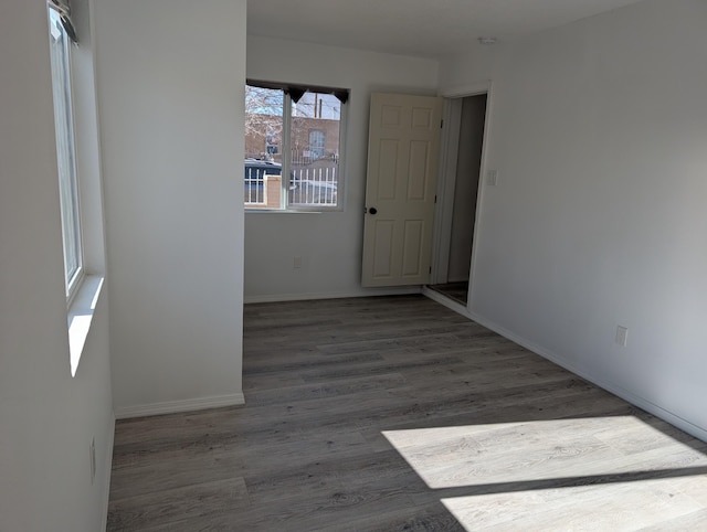 interior space with baseboards and wood finished floors