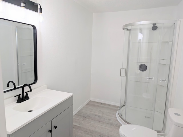 140 65th St NW, Albuquerque, NM 87105 - full bathroom with toilet, a shower stall, vanity, wood finished floors, and baseboards
