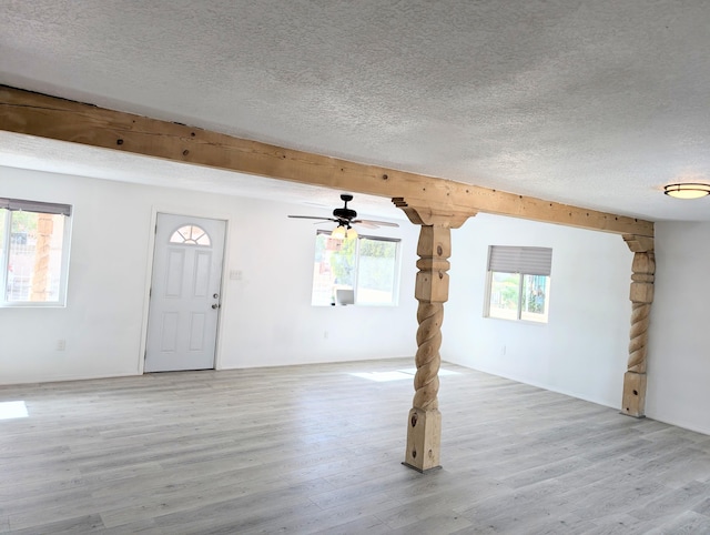 140 65th St NW, Albuquerque, NM 87105 - unfurnished living room featuring a textured ceiling, light wood-type flooring, and ceiling fan