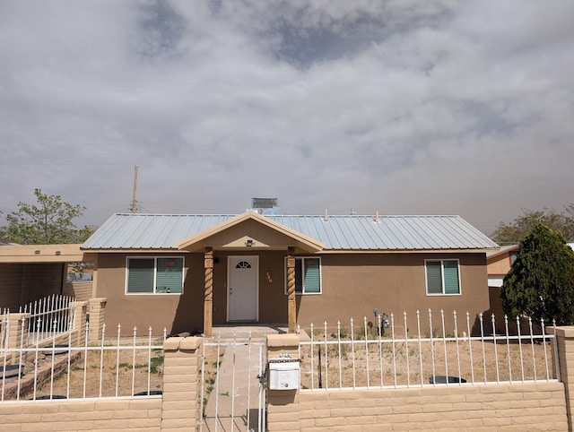 140 65th St NW, Albuquerque, NM 87105 - ranch-style house with stucco siding, a fenced front yard, a gate, and metal roof