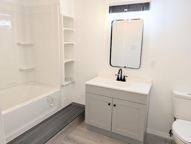 140 65th St NW, Albuquerque, NM 87105 - bathroom featuring toilet, vanity, wood finished floors, tub / shower combination, and baseboards
