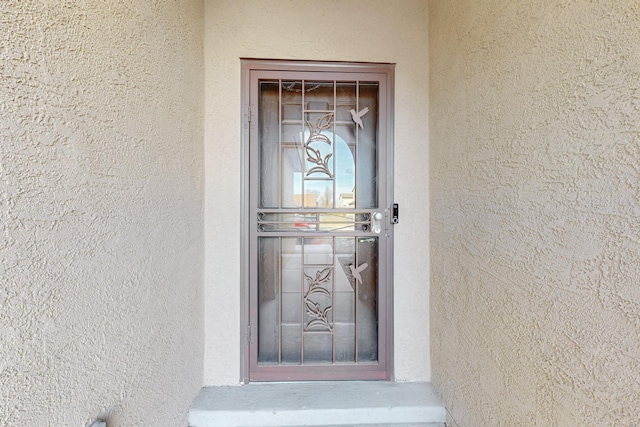 doorway to property with stucco siding